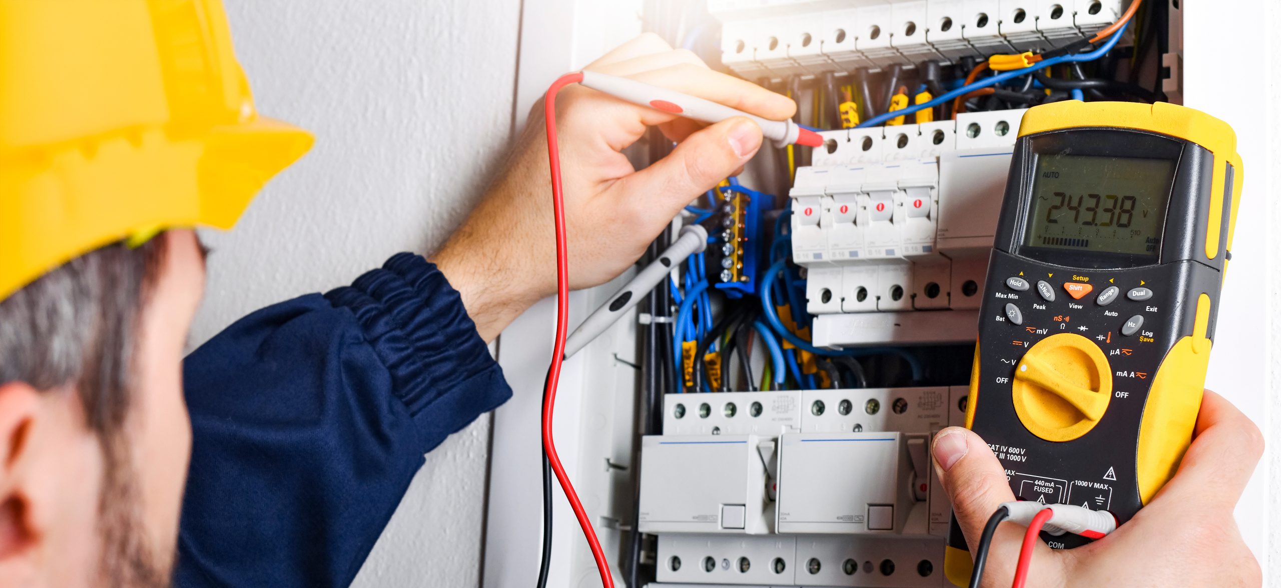 multimeter in hands of electricians detail.